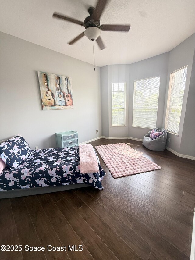 530 Carmel Dr, Melbourne, FL 32940 - bedroom featuring multiple windows, wood finished floors, and baseboards