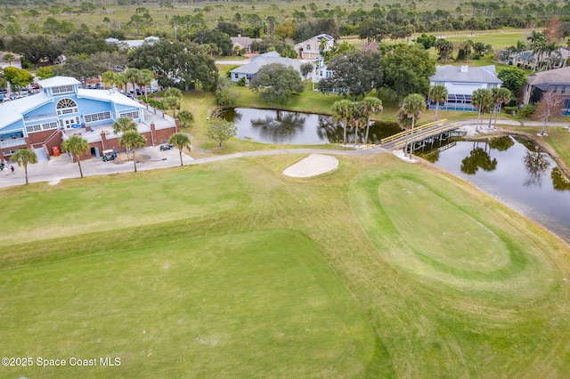 birds eye view of property with a water view and golf course view