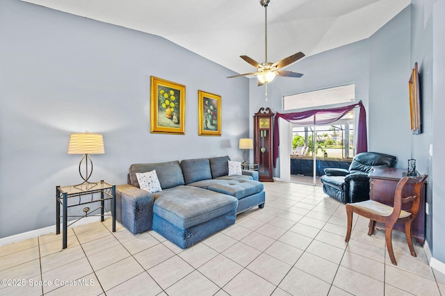 living room featuring light tile patterned floors, baseboards, lofted ceiling, and ceiling fan