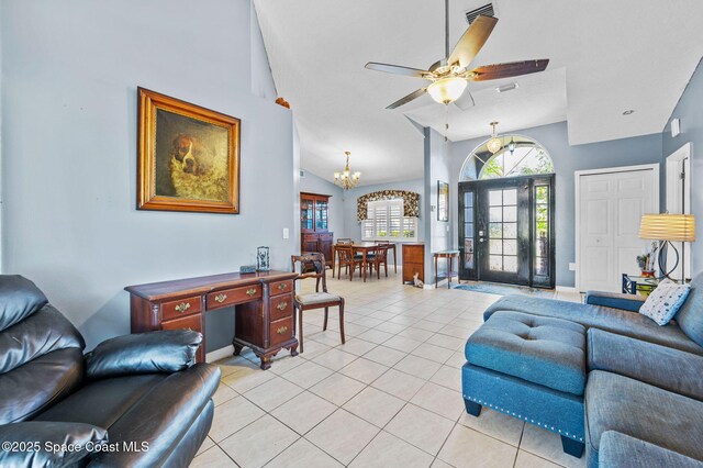 living area with light tile patterned flooring, ceiling fan with notable chandelier, visible vents, and high vaulted ceiling