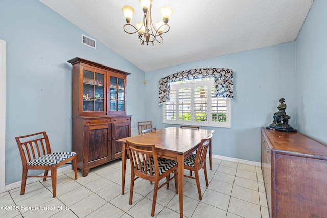 dining room featuring light tile patterned floors, baseboards, visible vents, lofted ceiling, and a chandelier