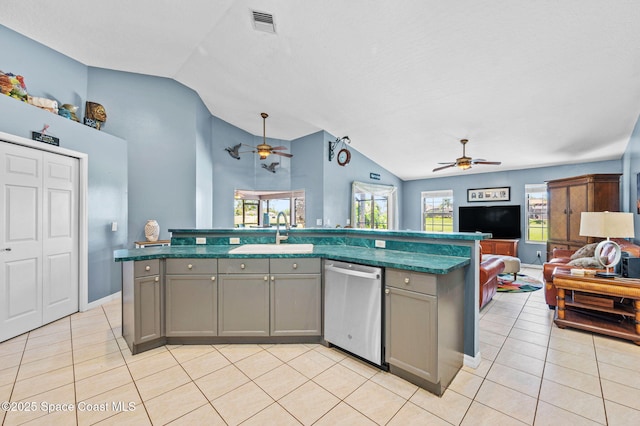 kitchen with light tile patterned flooring, gray cabinets, a sink, dishwasher, and open floor plan