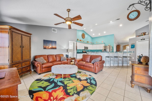 living area featuring light tile patterned floors, visible vents, high vaulted ceiling, recessed lighting, and ceiling fan