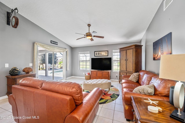 living area with light tile patterned floors, baseboards, visible vents, ceiling fan, and vaulted ceiling