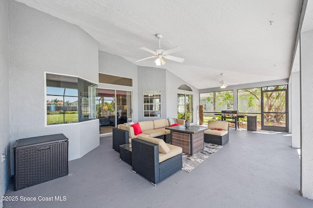 sunroom featuring lofted ceiling and a ceiling fan