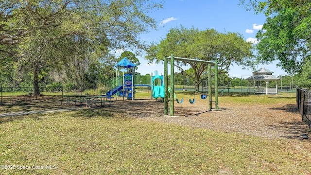 communal playground with fence and a lawn