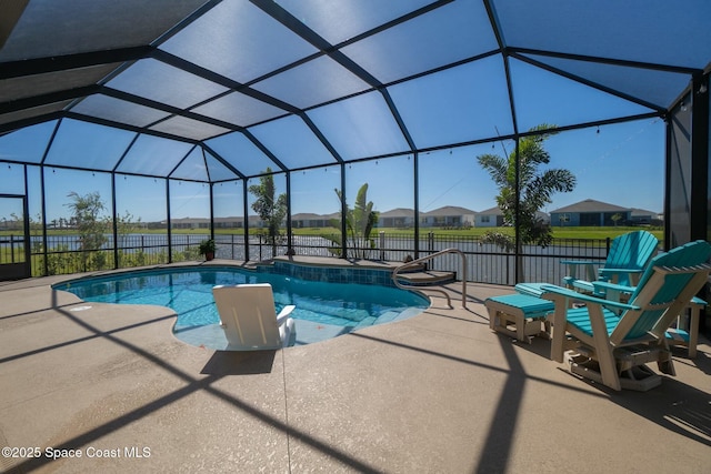 pool featuring a patio, fence, and glass enclosure