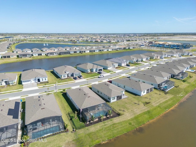 drone / aerial view featuring a water view and a residential view