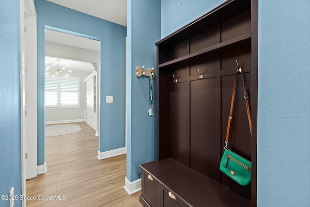 mudroom with light wood-style flooring and baseboards