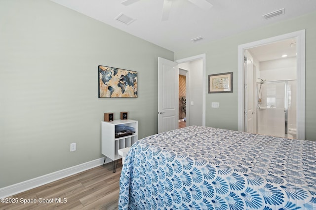 bedroom featuring light wood finished floors, visible vents, and baseboards