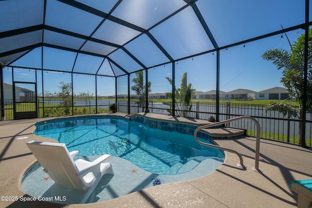 view of swimming pool with glass enclosure, a patio area, fence, and a fenced in pool