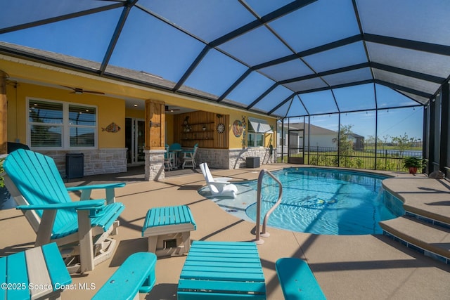 outdoor pool with a lanai, a patio area, ceiling fan, and fence