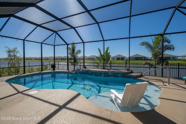 pool with glass enclosure, a patio area, and fence