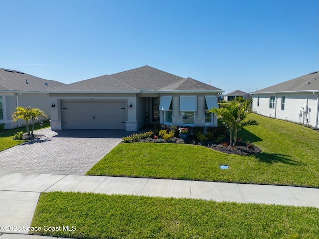 view of front of property with a garage, roof with shingles, decorative driveway, a front yard, and stucco siding