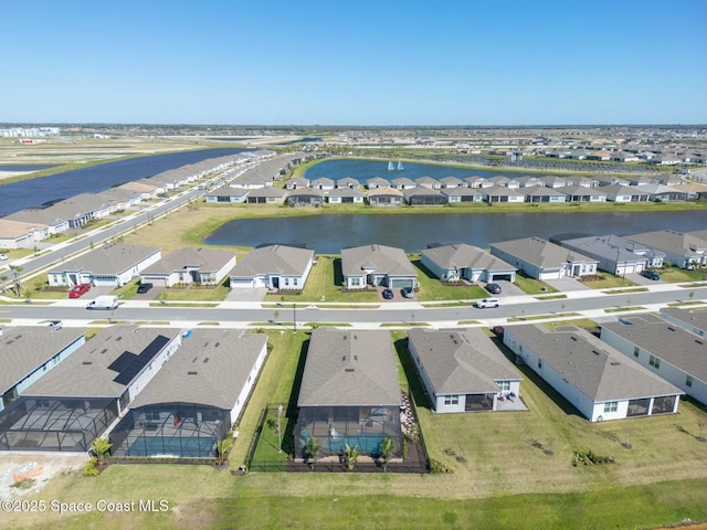 birds eye view of property with a water view and a residential view