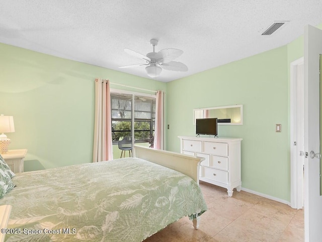 bedroom featuring visible vents, a ceiling fan, light tile patterned flooring, a textured ceiling, and baseboards