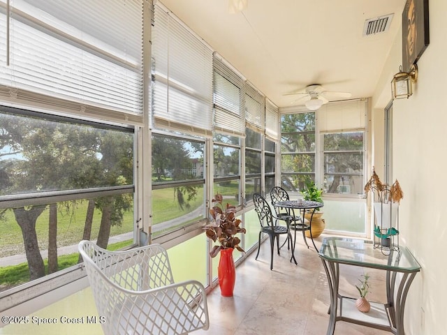 sunroom with visible vents and a ceiling fan