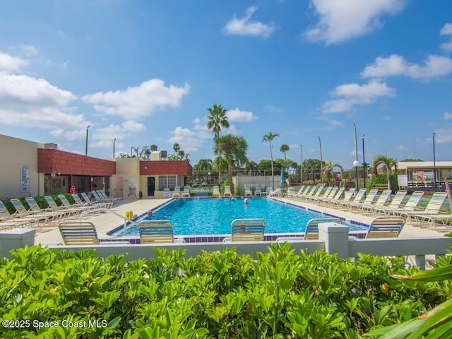 pool featuring a patio area and fence