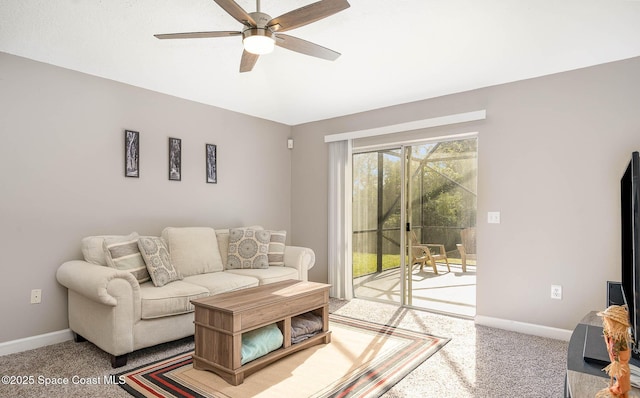 living room featuring carpet, ceiling fan, and baseboards