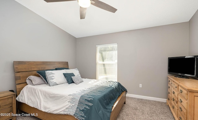 bedroom featuring a ceiling fan, lofted ceiling, light carpet, and baseboards