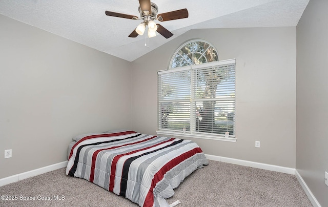 bedroom featuring carpet flooring, vaulted ceiling, a textured ceiling, and baseboards