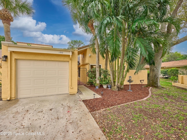 view of front of property featuring concrete driveway and stucco siding