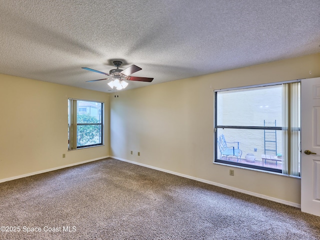 spare room with carpet flooring, ceiling fan, and baseboards