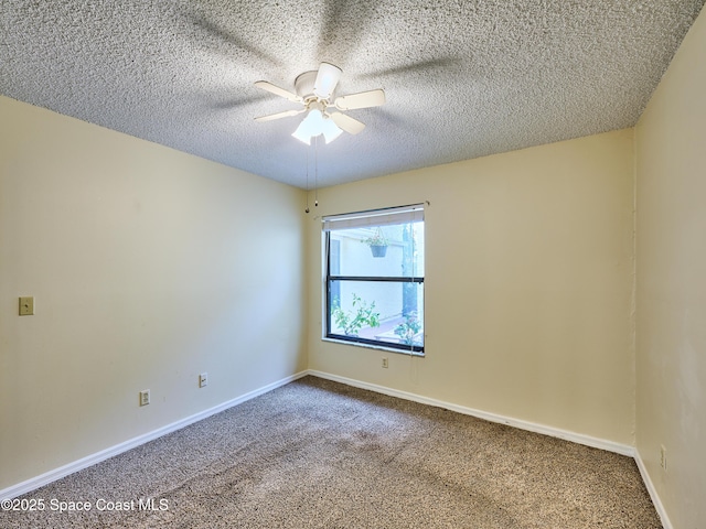 carpeted spare room with ceiling fan, baseboards, and a textured ceiling