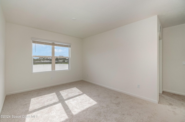 carpeted spare room with baseboards