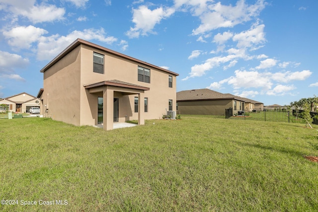 back of property featuring a yard, central AC unit, a patio area, and fence