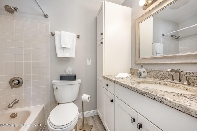 full bath featuring baseboards, toilet, shower / tub combination, wood finished floors, and vanity