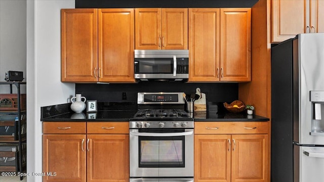 kitchen featuring appliances with stainless steel finishes and brown cabinets