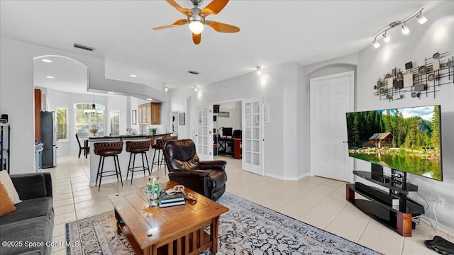 living room featuring french doors, recessed lighting, a ceiling fan, light tile patterned flooring, and baseboards