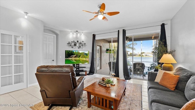 living room with ceiling fan and light tile patterned floors