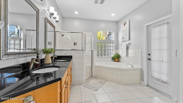 full bathroom featuring a garden tub, a shower stall, and a sink