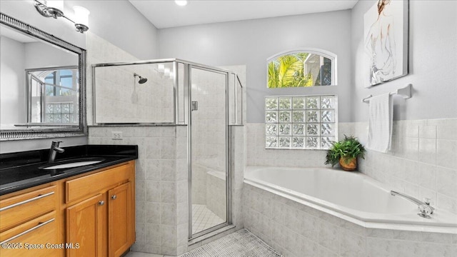 full bath featuring a garden tub, a shower stall, and a wealth of natural light