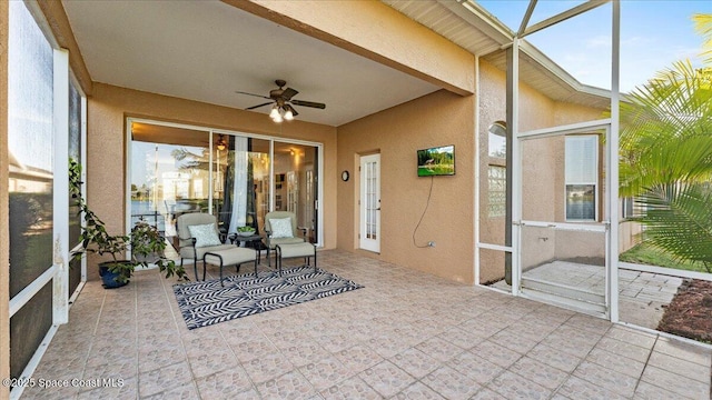 sunroom / solarium featuring a ceiling fan