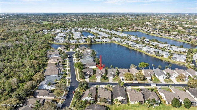 drone / aerial view with a water view and a residential view