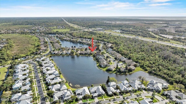 birds eye view of property with a water view and a residential view