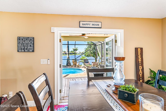 dining area featuring baseboards and a sunroom