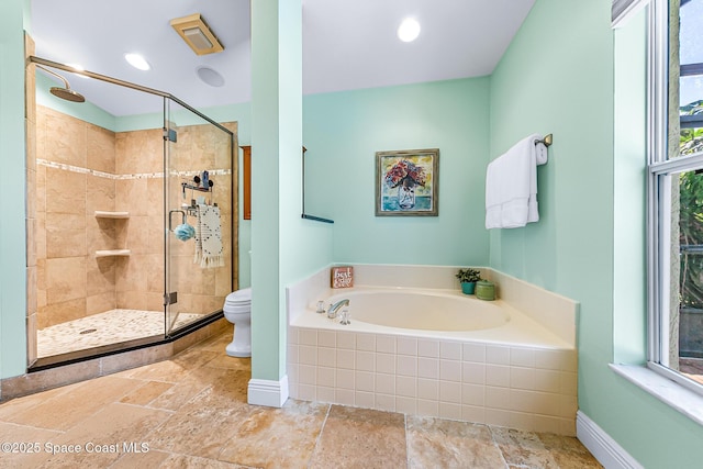 full bathroom with a garden tub, toilet, a stall shower, and stone tile flooring