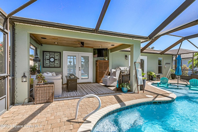 outdoor pool featuring a lanai, french doors, and a patio