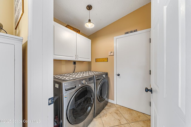 washroom featuring light tile patterned floors, cabinet space, independent washer and dryer, and a textured ceiling