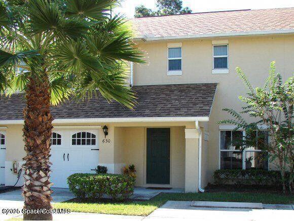 view of front of house featuring a garage, roof with shingles, and stucco siding