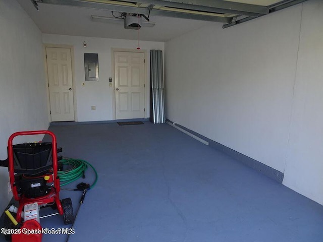 garage featuring electric panel and a garage door opener