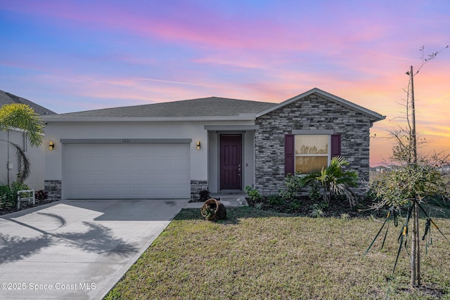 single story home with a garage, stone siding, concrete driveway, a lawn, and stucco siding