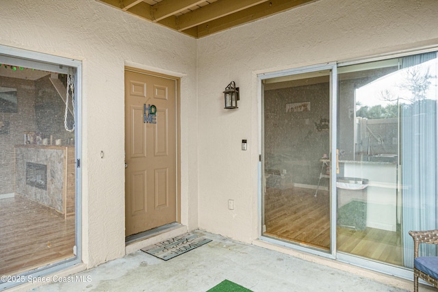 entrance to property featuring stucco siding