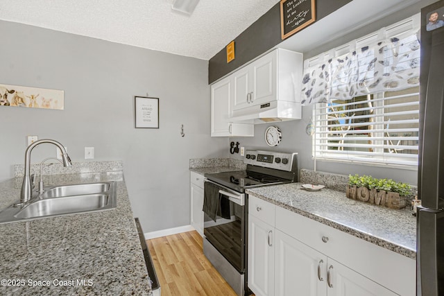 kitchen with appliances with stainless steel finishes, light wood-style floors, white cabinetry, a sink, and under cabinet range hood