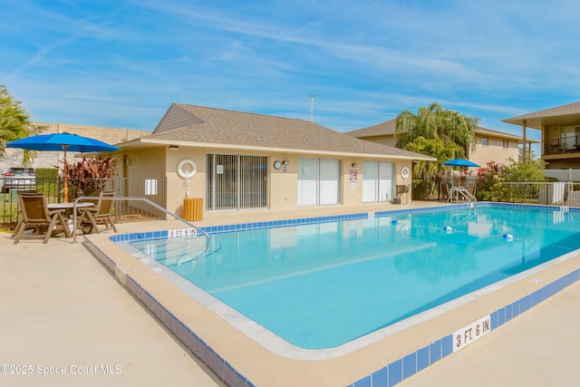 pool featuring a patio area and fence