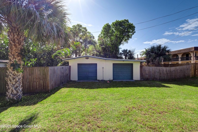 detached garage featuring fence